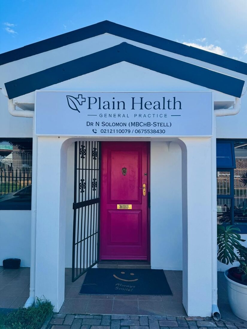 The practice entrance, with the Plain Health sign above a pink door